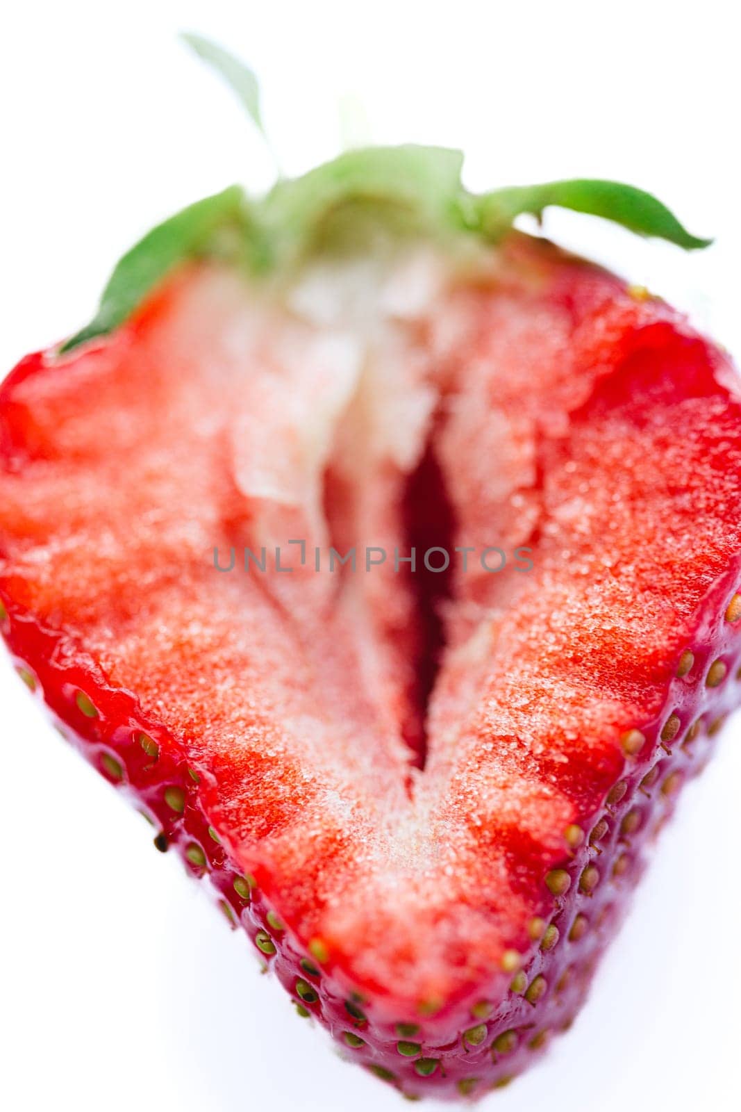 Ripe half of a strawberry on a white background. by sarymsakov