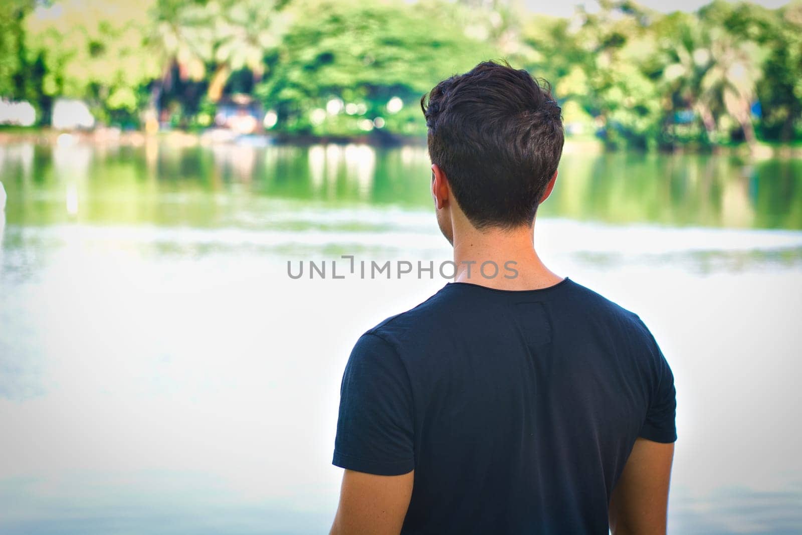 Man Standing in Front of Serene Body of Water by artofphoto