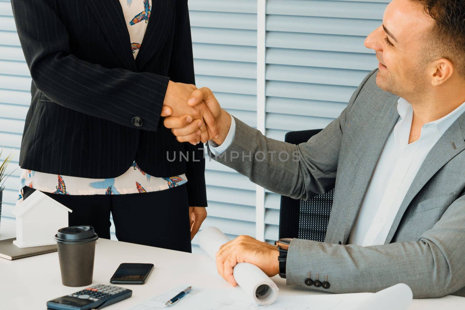 Businessman executive handshake with businesswoman worker in modern workplace office. People corporate business deals concept. uds