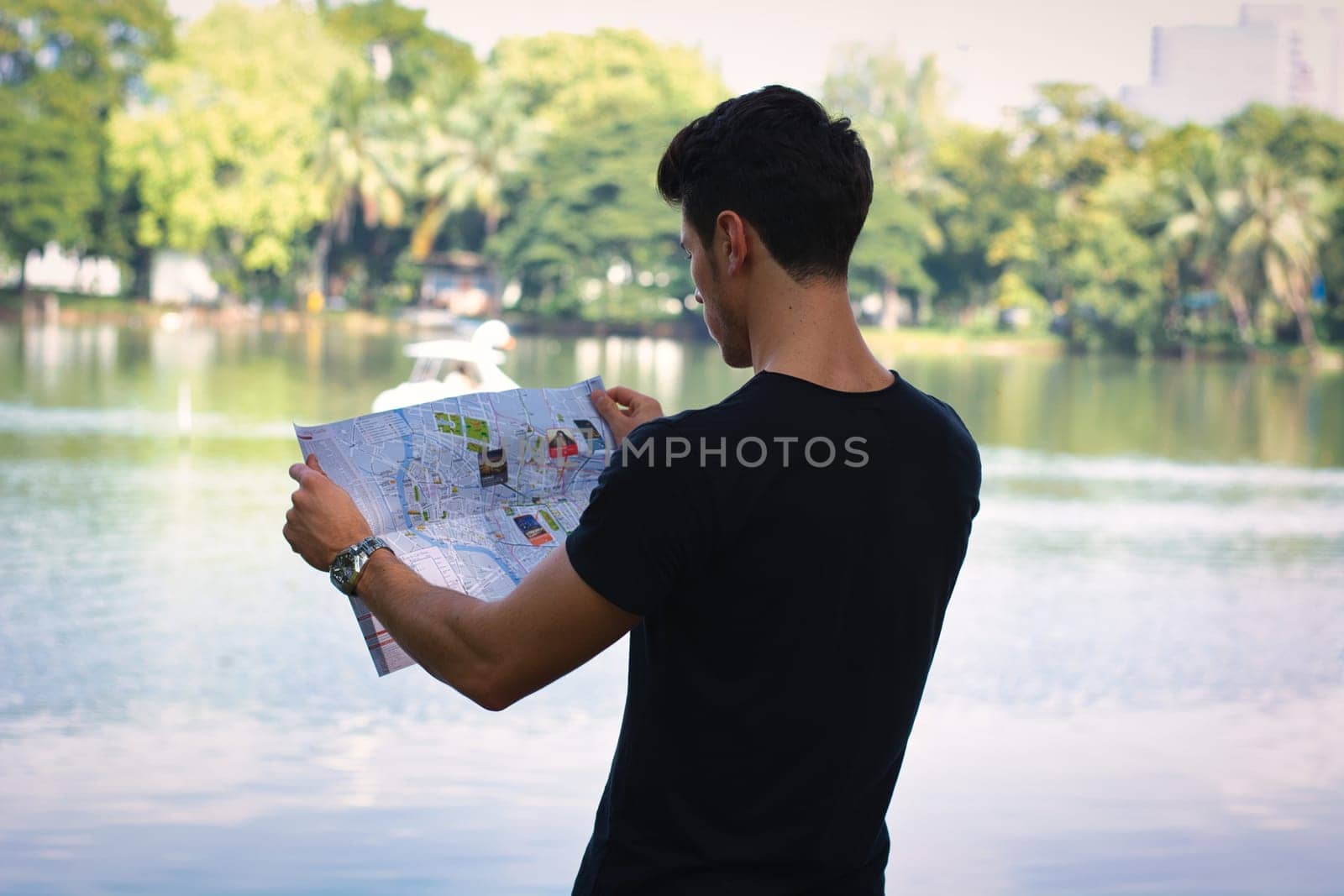 Man Studying Map by the Lake by artofphoto