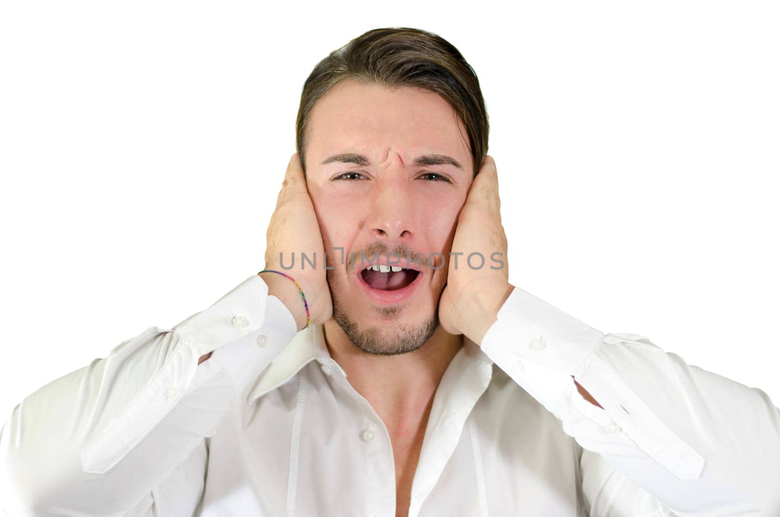 Too much noise, attractive young man covering his ears, isolated on white