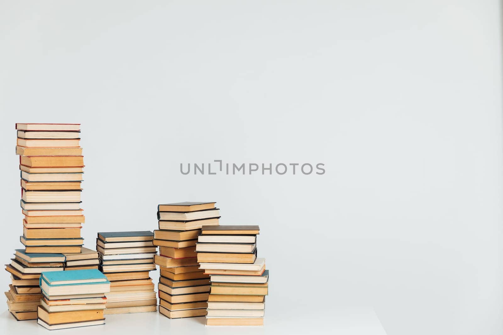 Stacks of books in university library on white background