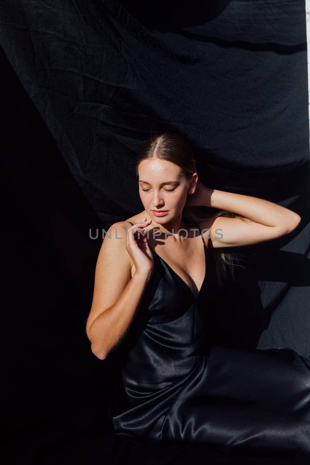 Portret of beautiful fashionable woman in black silk dress