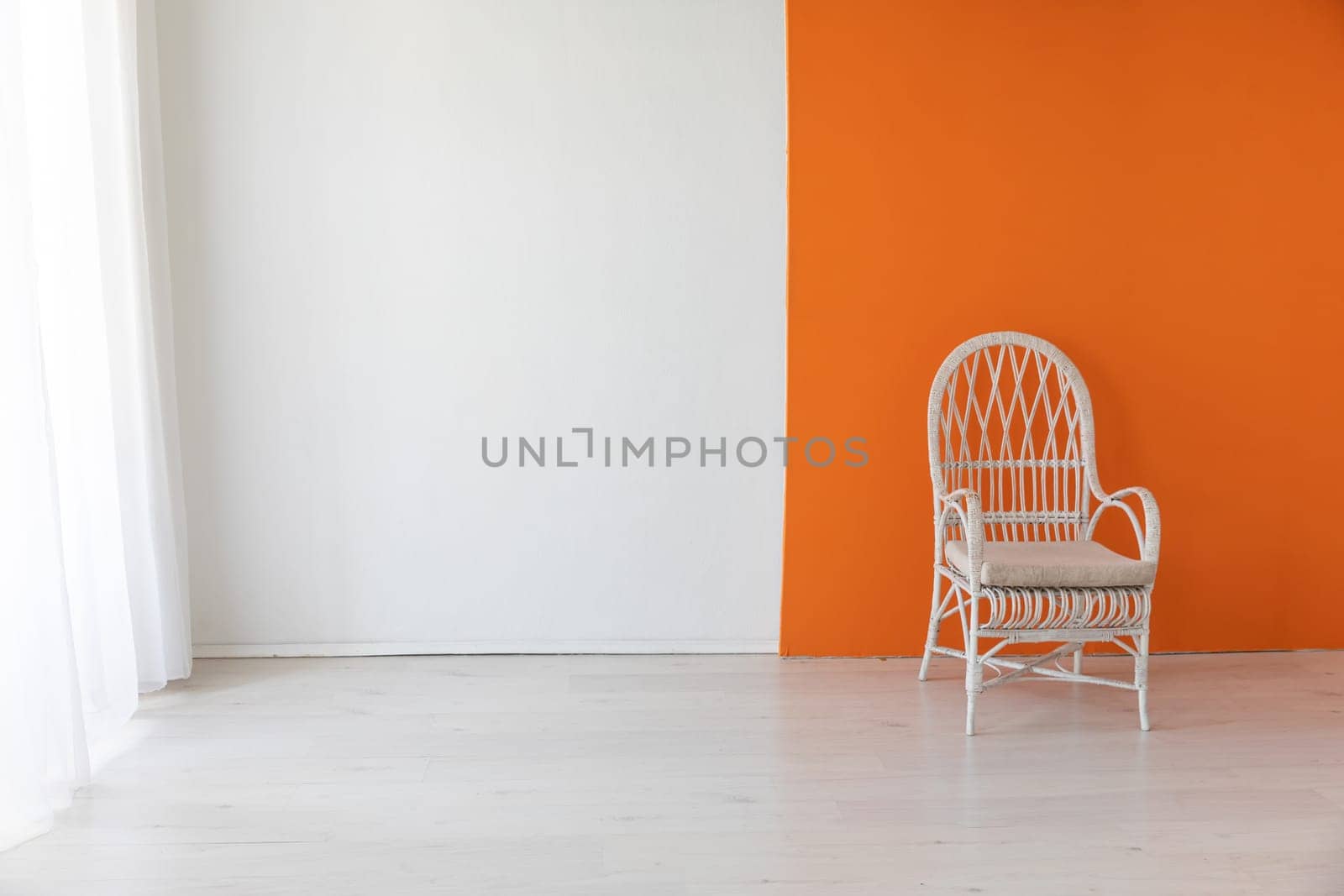 Vintage chair in the interior of an empty white and orange room by Simakov