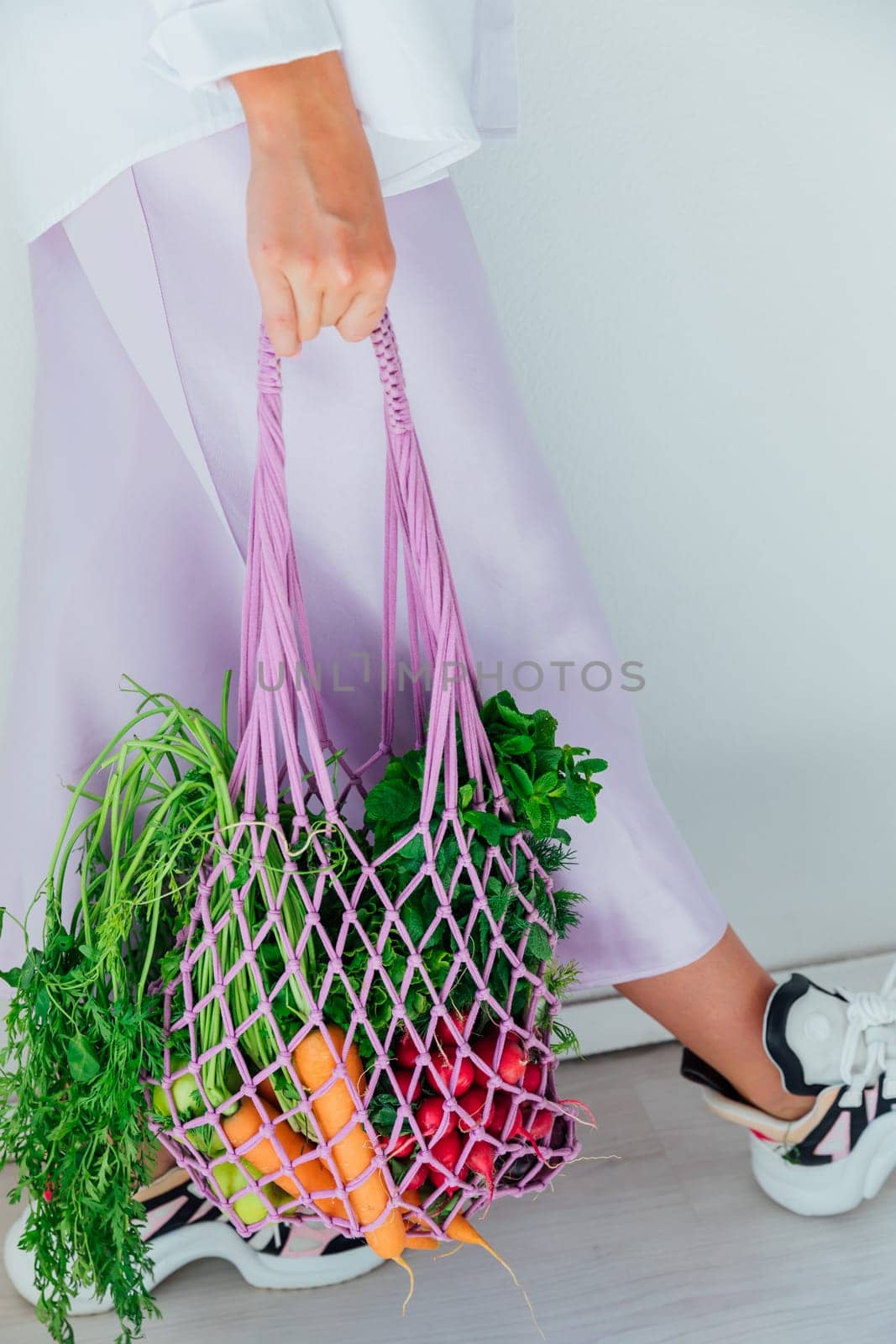Female holding bag with vegetables for cooking