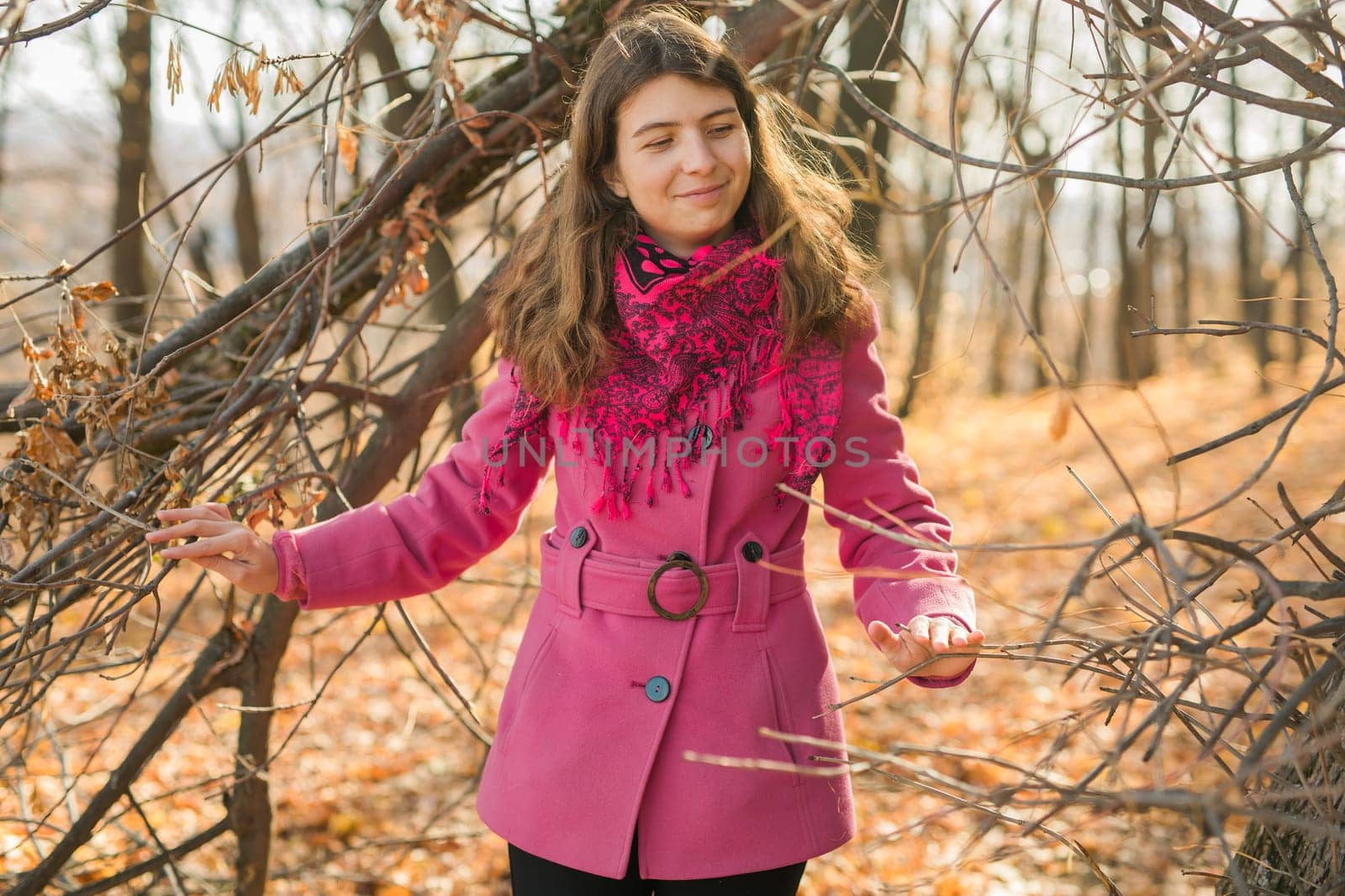 Beautiful happy smiling girl with long hair wearing black hat and pink jacket posing in autumn park. Outdoor portrait day light. Autumn mood concept. Generation Z and gen z youth. Copy empty space for text. by Satura86