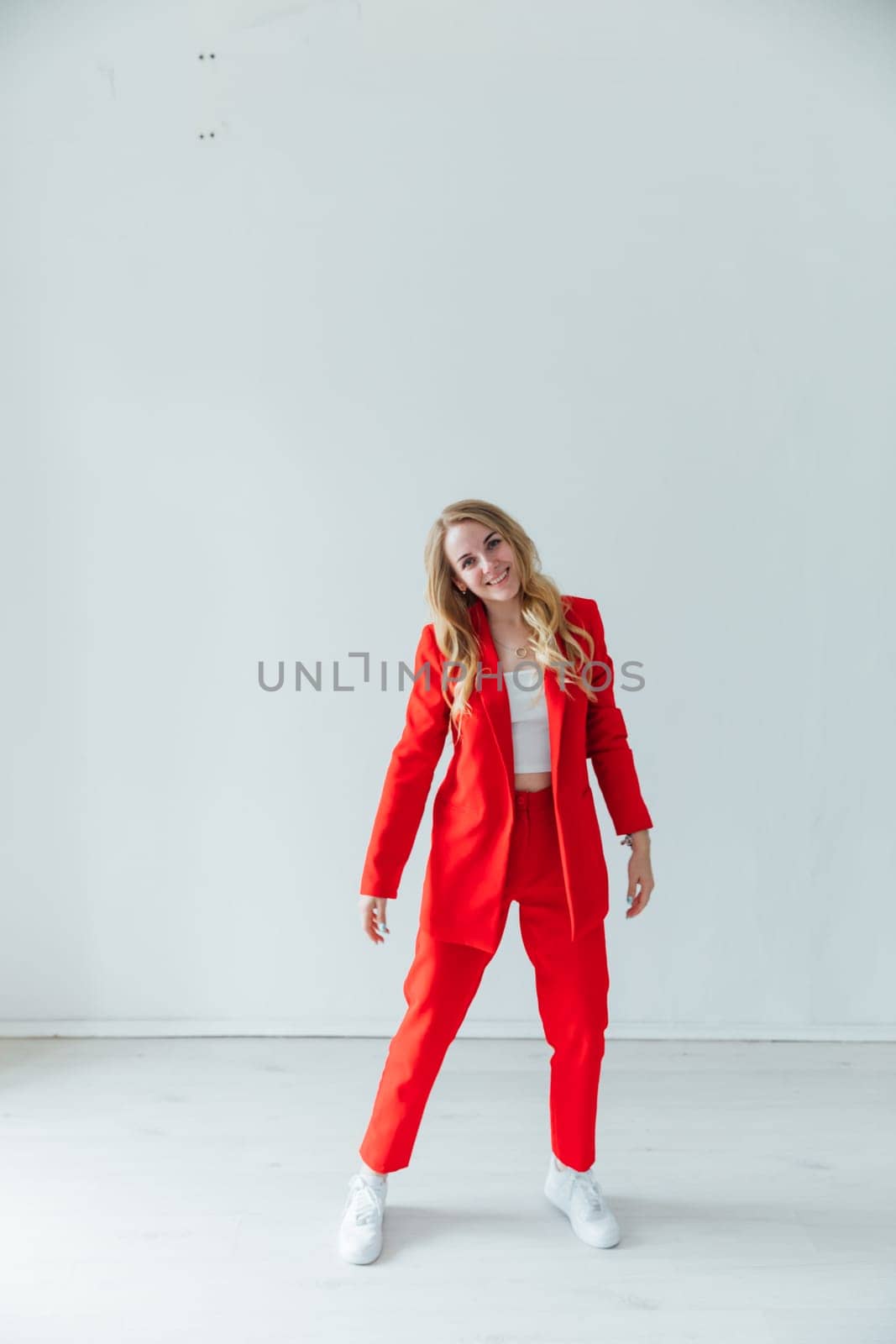 Beautiful blonde woman in red business suit by Simakov