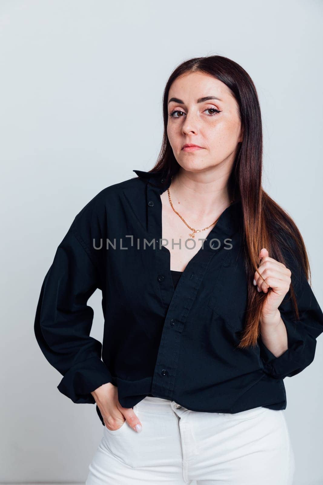 brunette woman in black blouse and white pants by Simakov