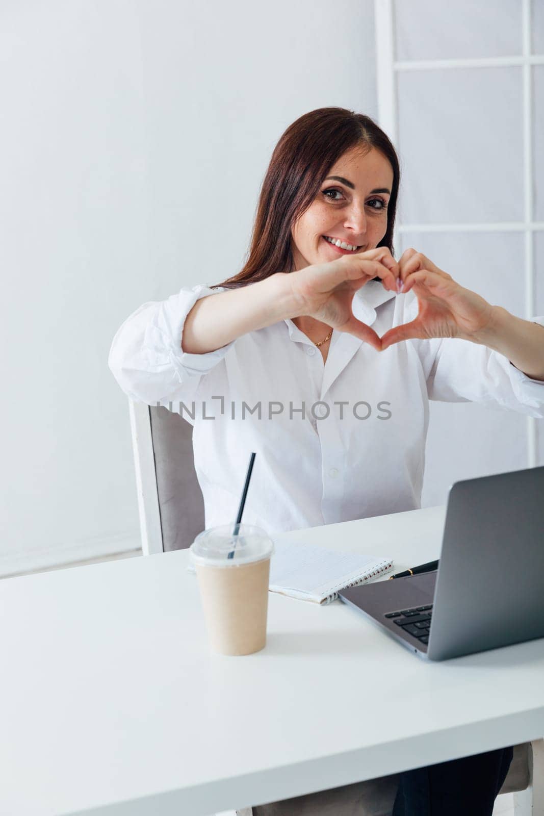 Beautiful businesswoman rejoicing, smiling and waving her arms