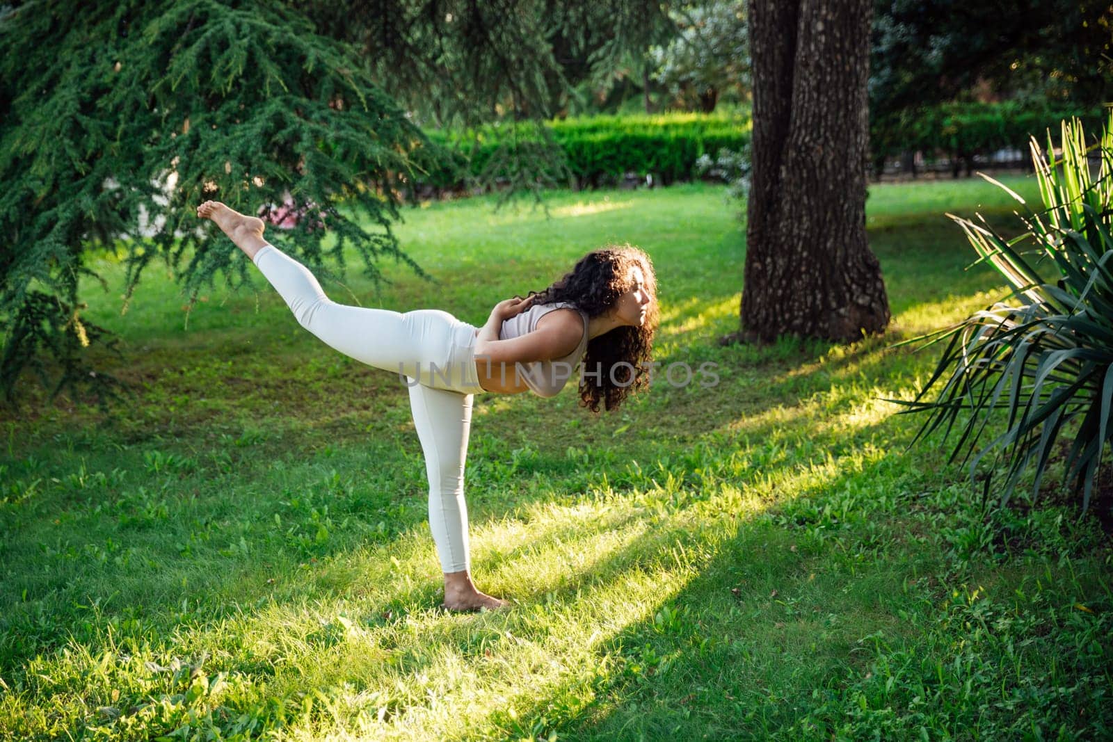 Woman doing yoga exercises asana breathing balance by Simakov