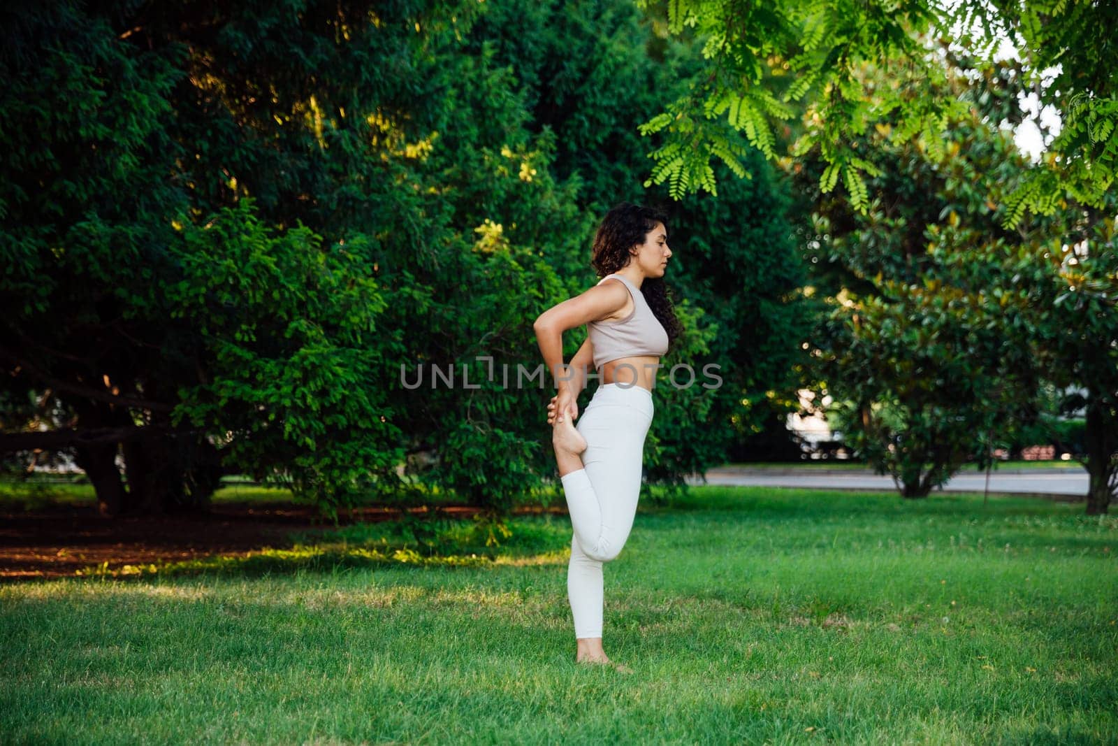 Woman doing yoga exercises asana breathing balance by Simakov