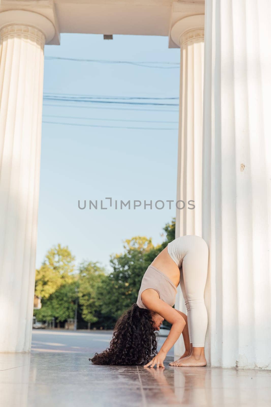 Woman doing yoga asana gymnastics breathing practice stretching by Simakov