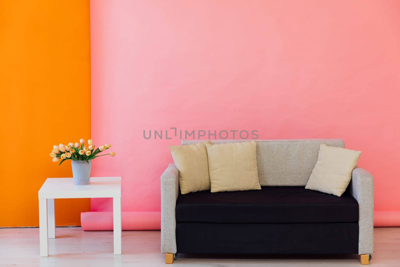 Black and grey office sofa in the interior of a multicolored room by Simakov