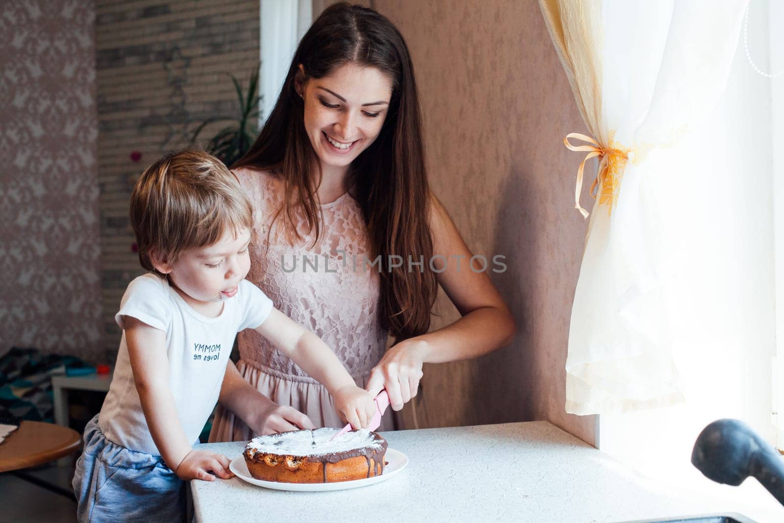 mother and son eating pie cooked in the kitchen yourself