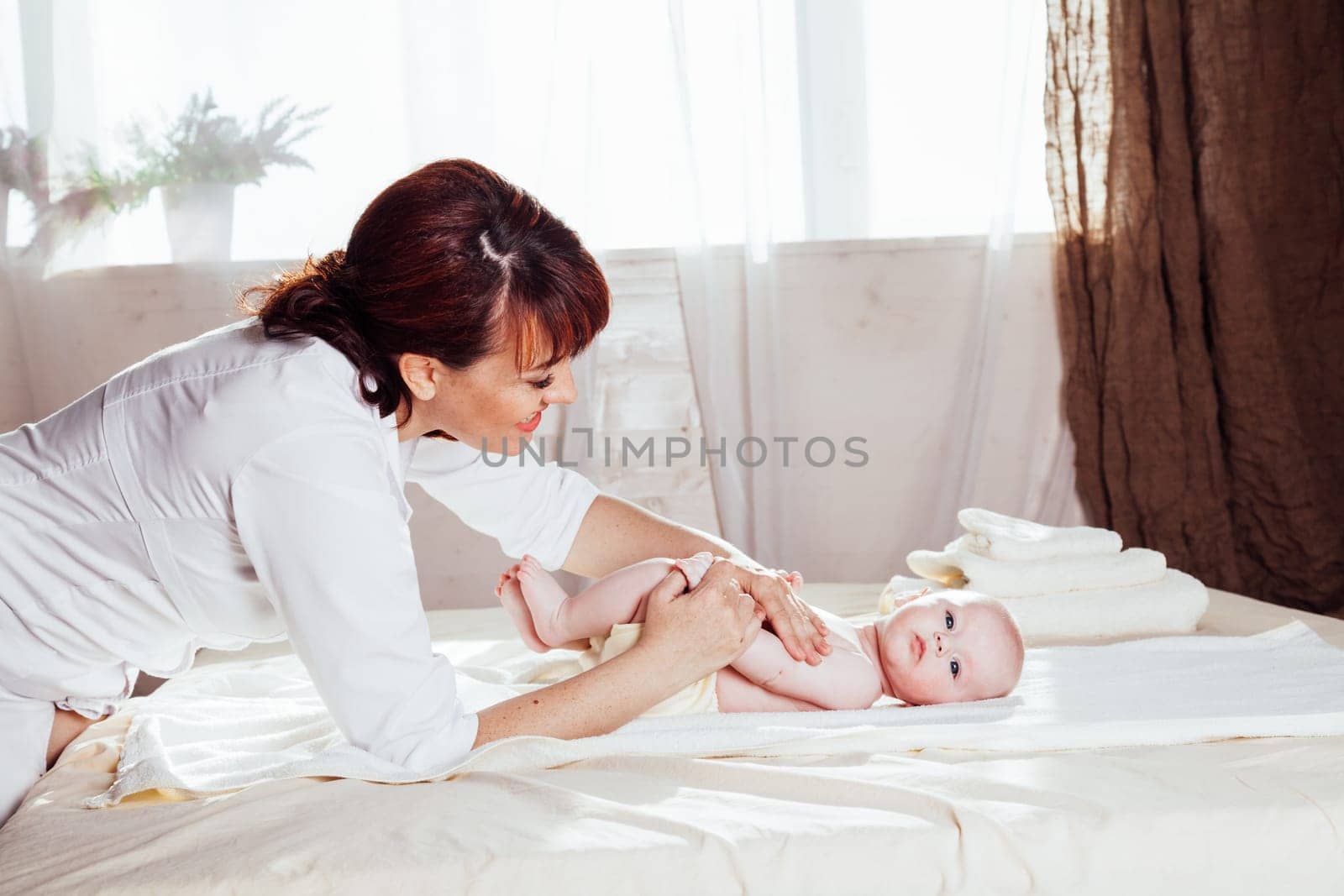 the little boy baby doctor doing massage by Simakov