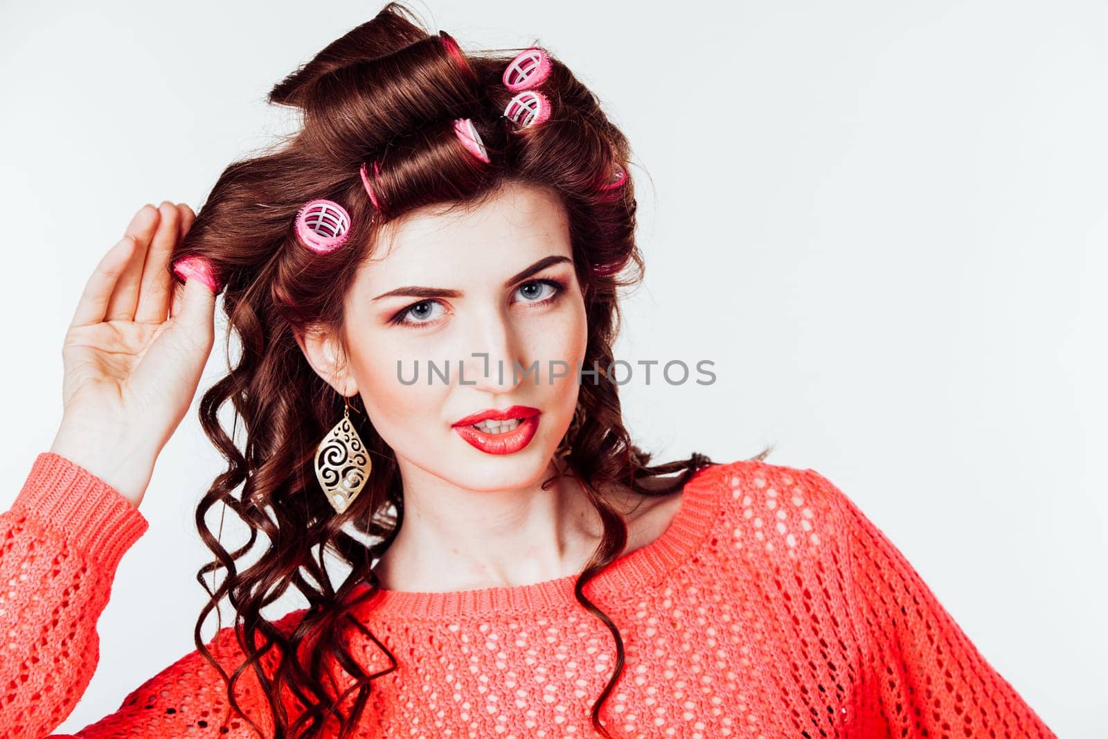 girl with curling irons makes hair style by Simakov