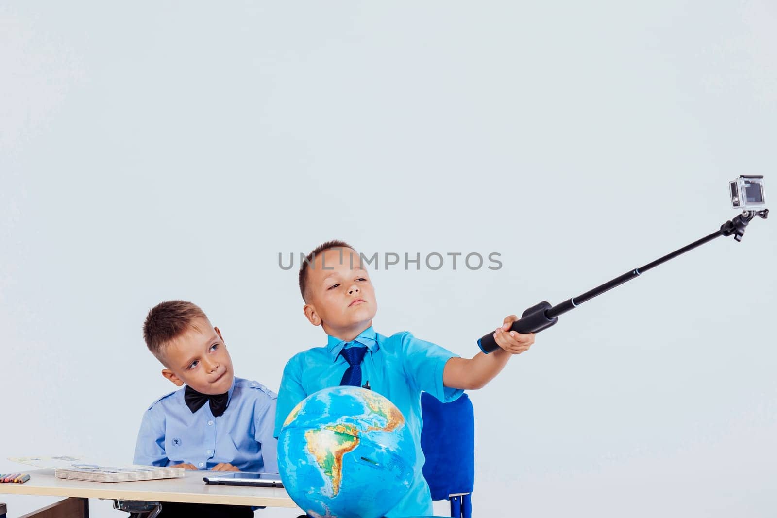 two boy photographed herself at her desk at school