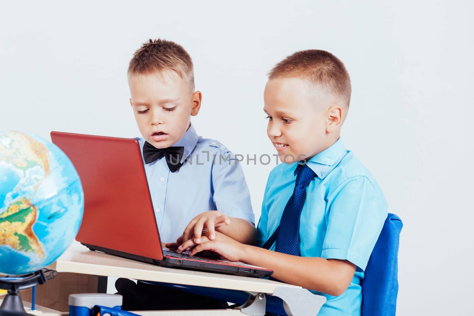 two boys sit at the computer training school by Simakov
