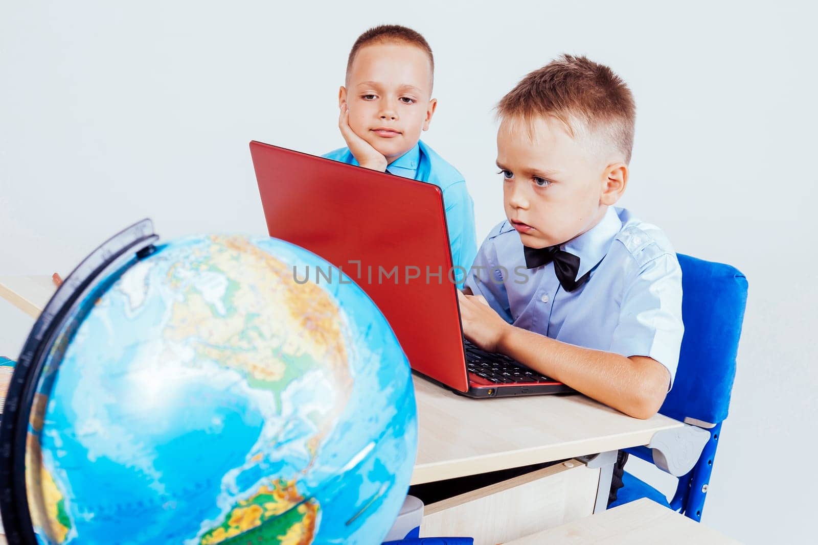 two boys sit at the computer training school by Simakov