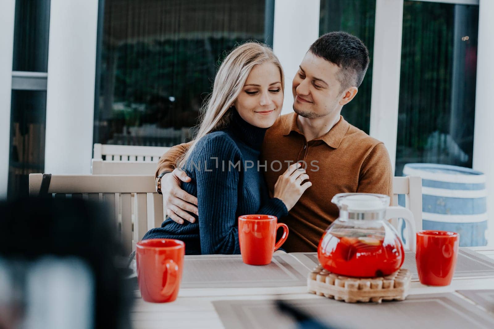 restaurant on the street. a guy with a girl drink hot coffee and tea 1