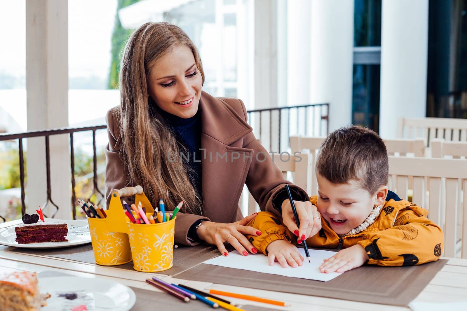 mother and son draw drawing hands colored pencils