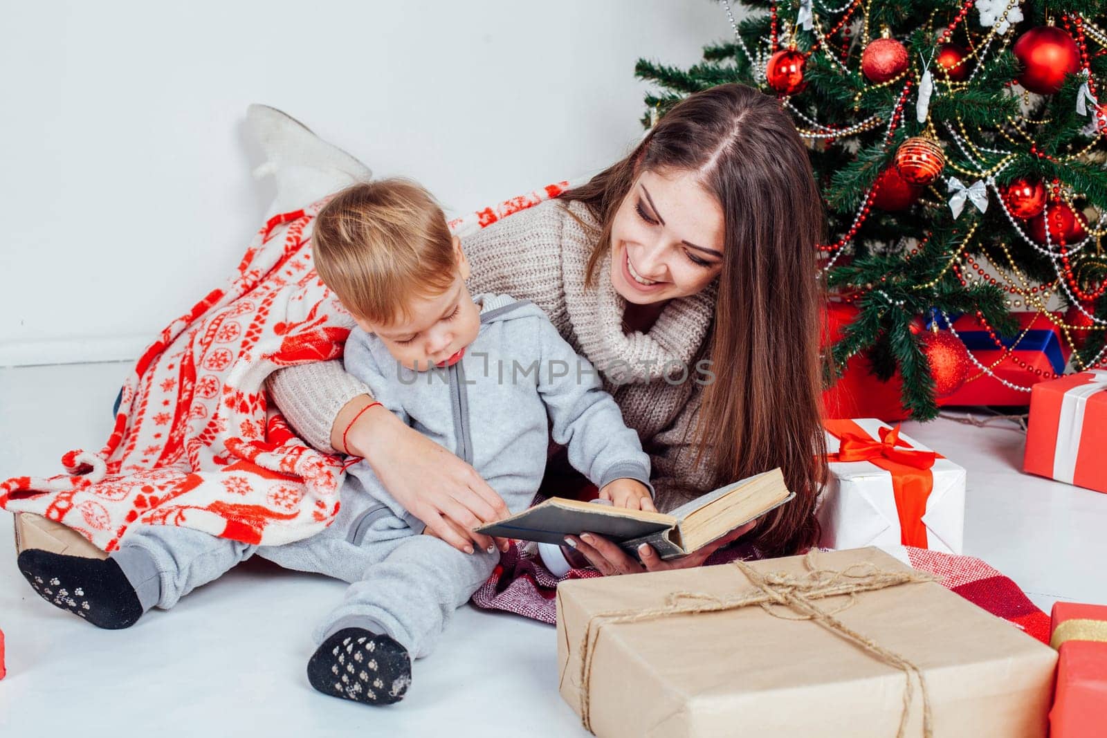 mother reading a book to a child at Christmas new year 1