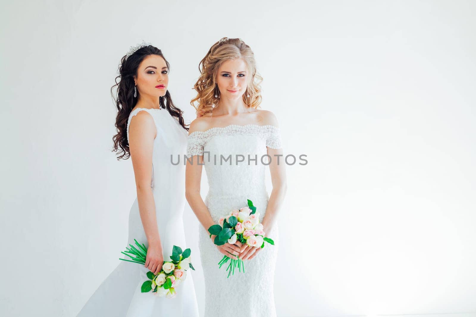 two wedding bride with a bouquet of flowers wedding hair blonde and brunette