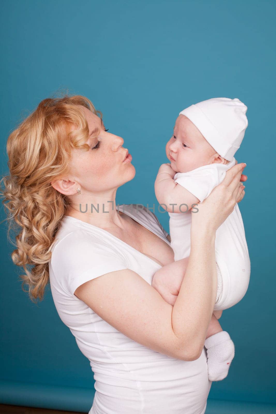 mom in white clothes with her son baby in love happiness