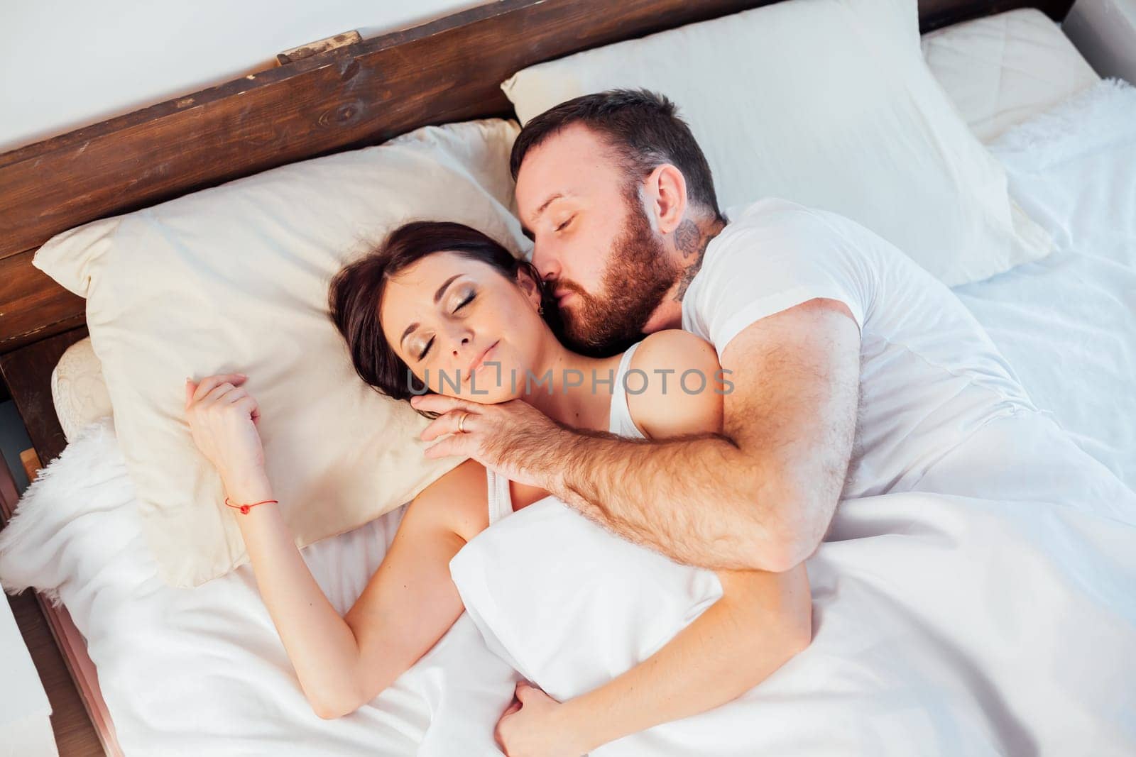 a man and a woman sleeping in beds at home 1