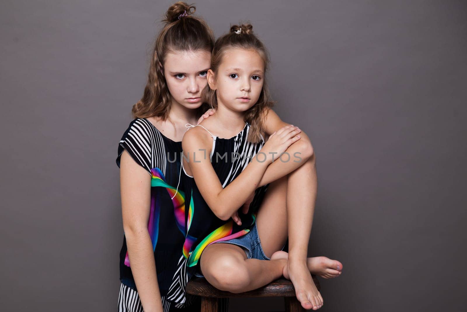 Two fashionable beautiful girls sister girlfriend portrait by Simakov