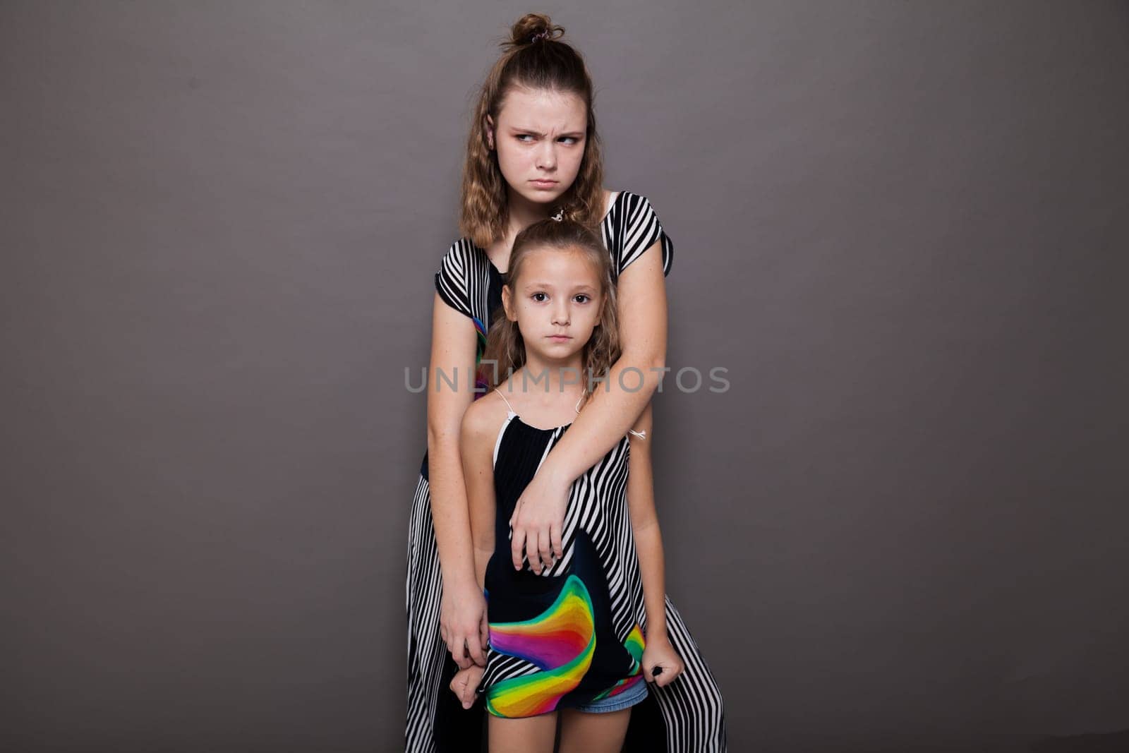 Two fashionable beautiful girls sister girlfriend portrait by Simakov