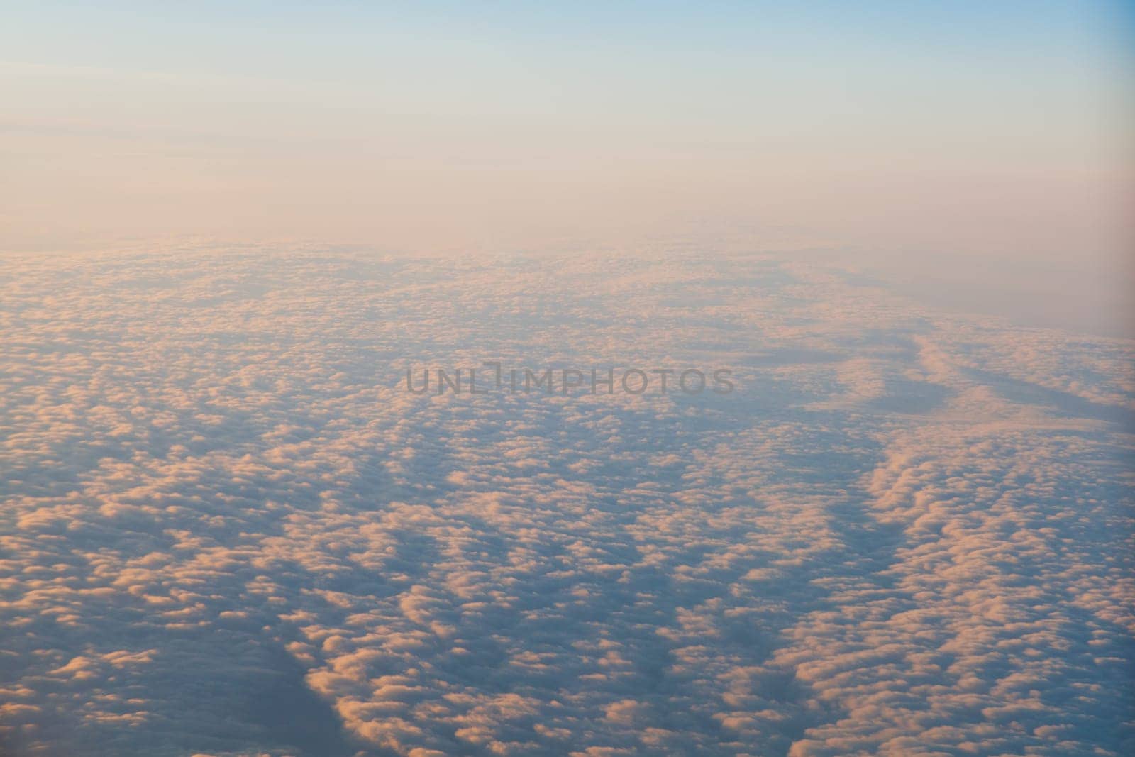 clouds at sunset from the plane in the sky landscape by Simakov