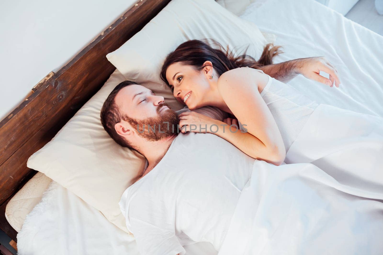 a man and a woman sleeping in beds at home 1