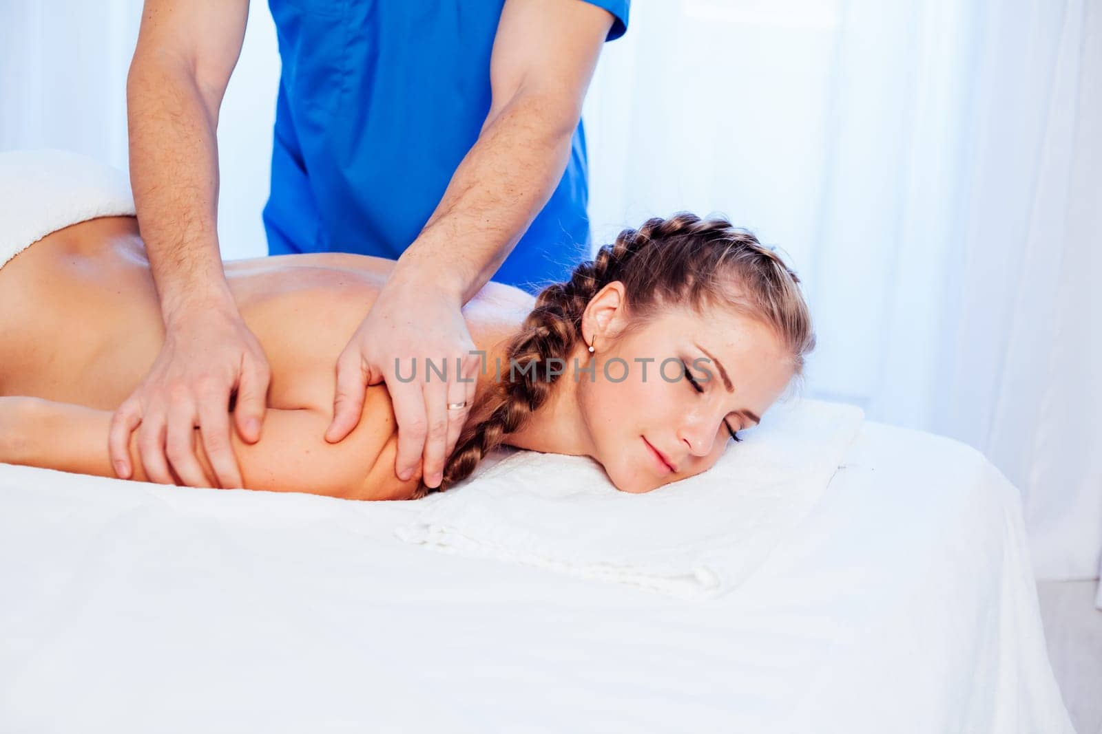 a woman doing a back massage in the Spa