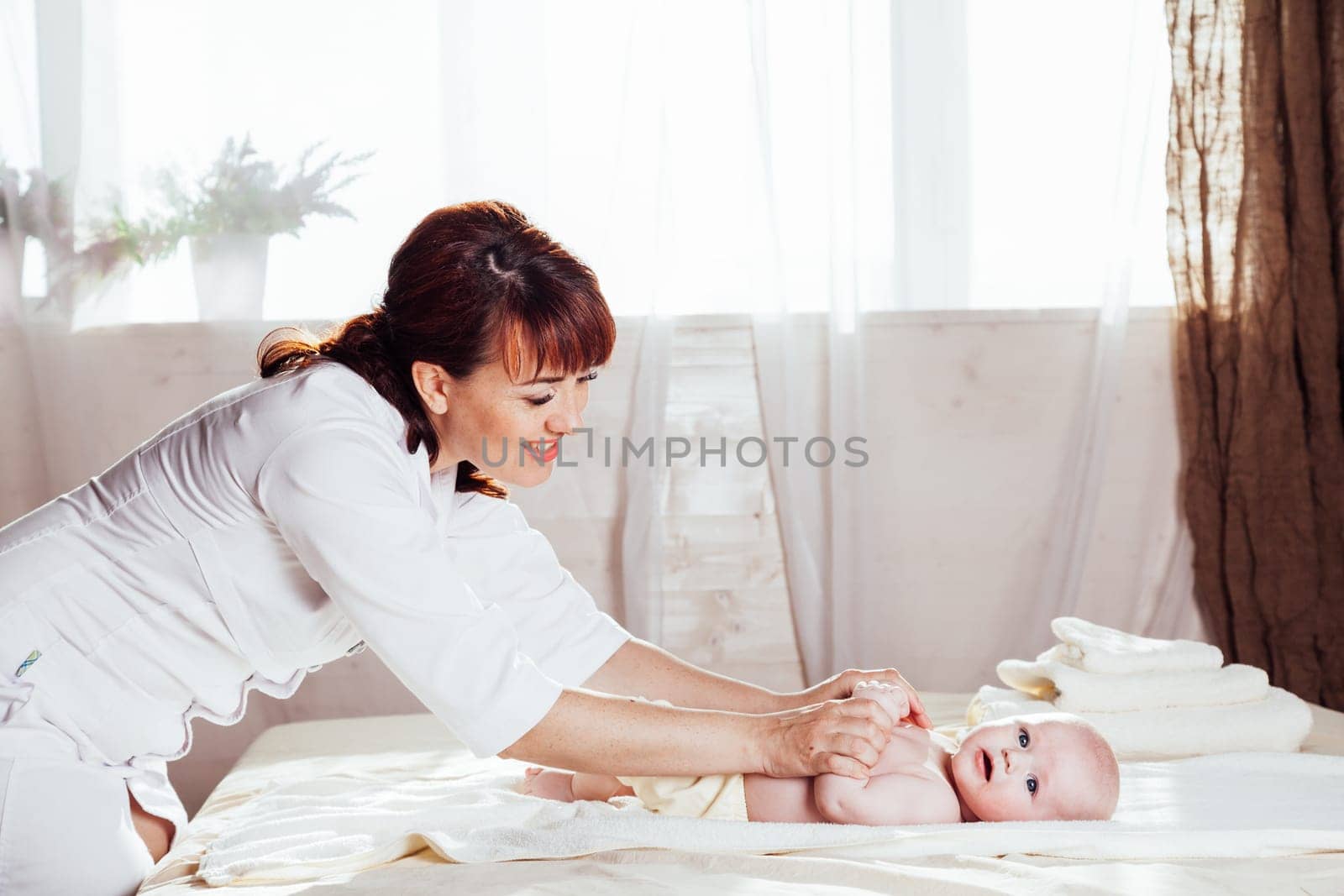 the little boy baby mother doing massage hands and legs 1