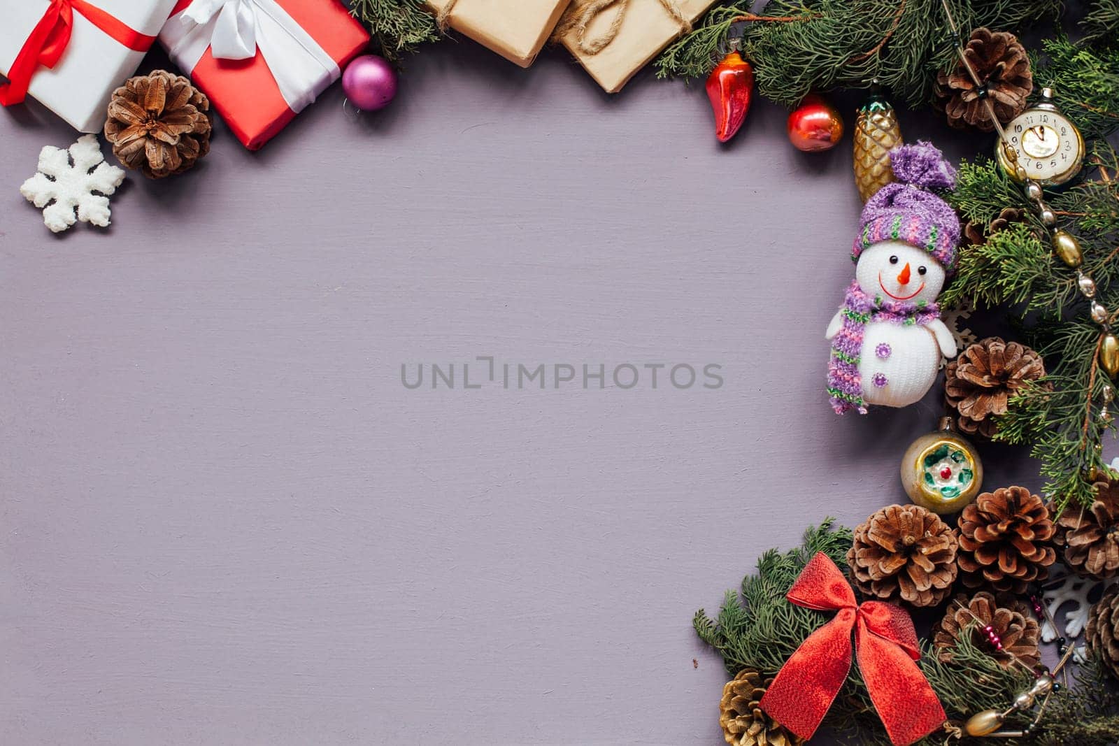 Christmas toys festive gifts decor new year on a purple background by Simakov