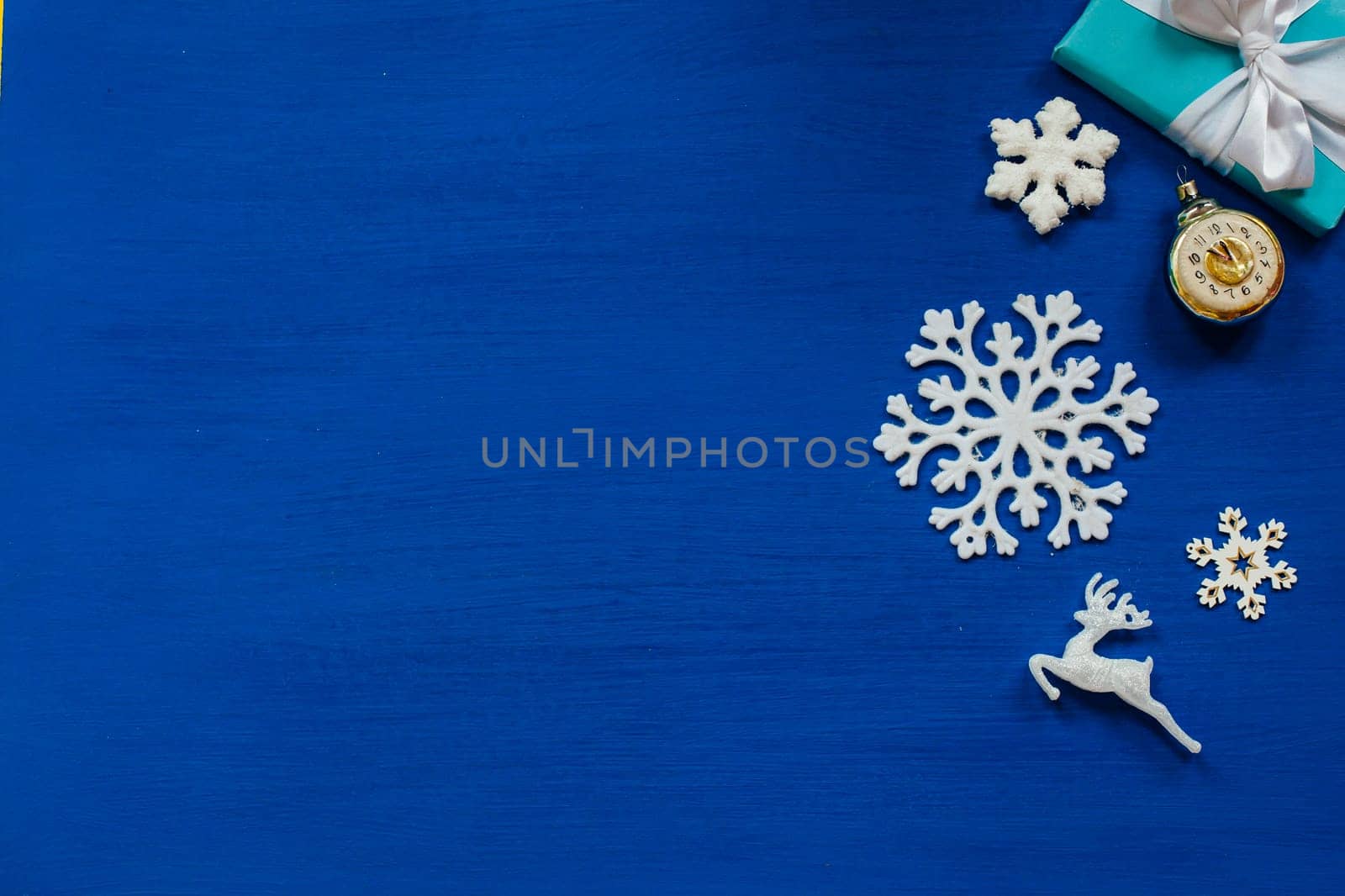 Christmas toys snowflakes presents the new year on a blue background by Simakov