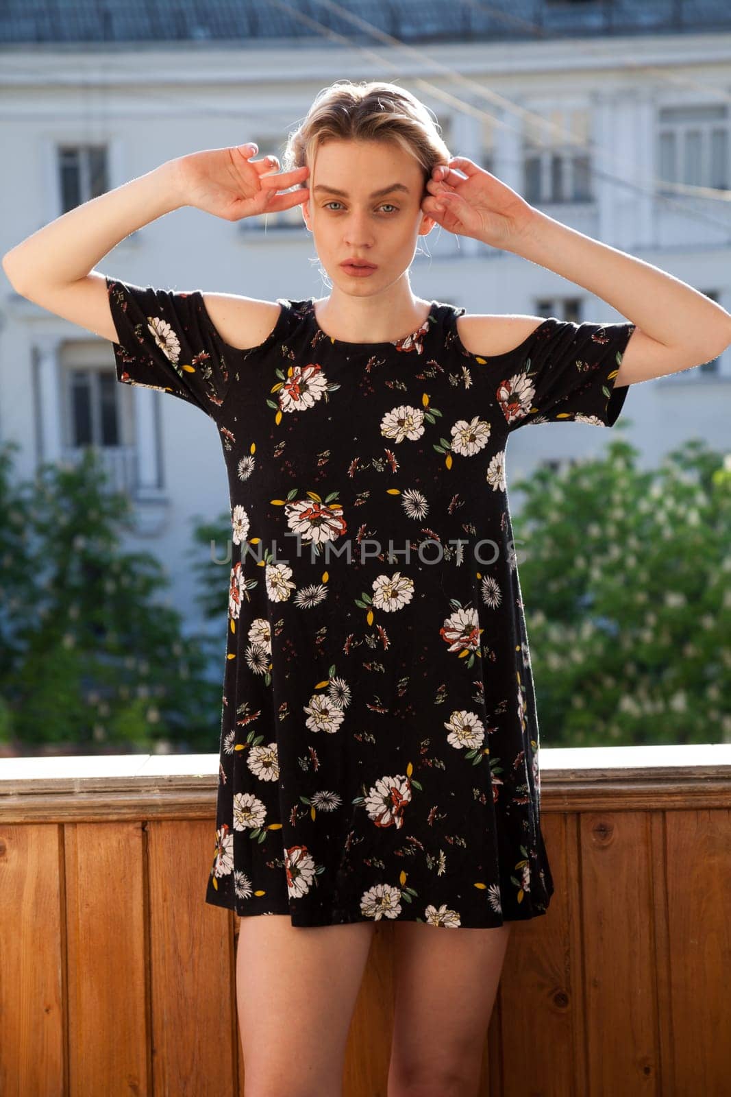 Beautiful blonde woman in fashionable dress clothes with flowers