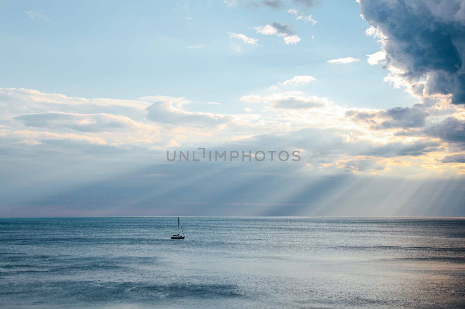 yacht in the sea rays from clouds landscape 2