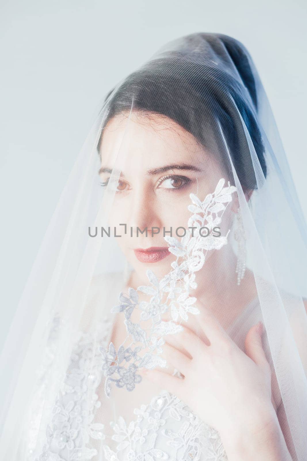 Portrait of a bride in a wedding dress veils