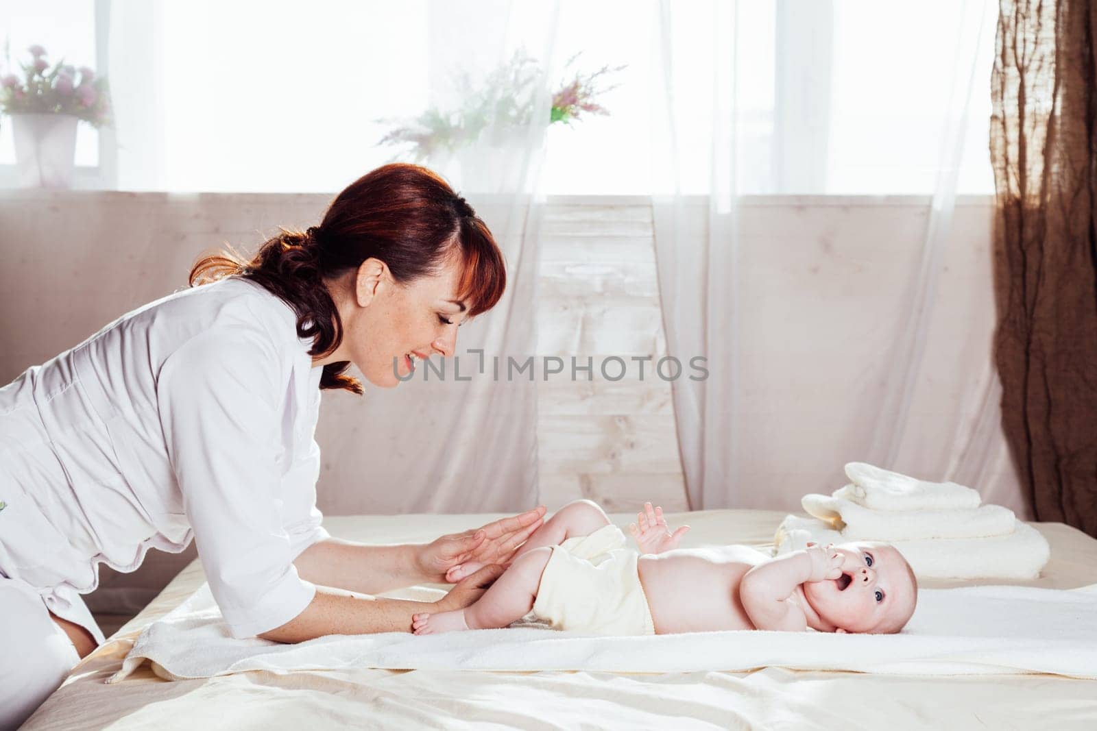 the little boy baby doctor doing massage by Simakov