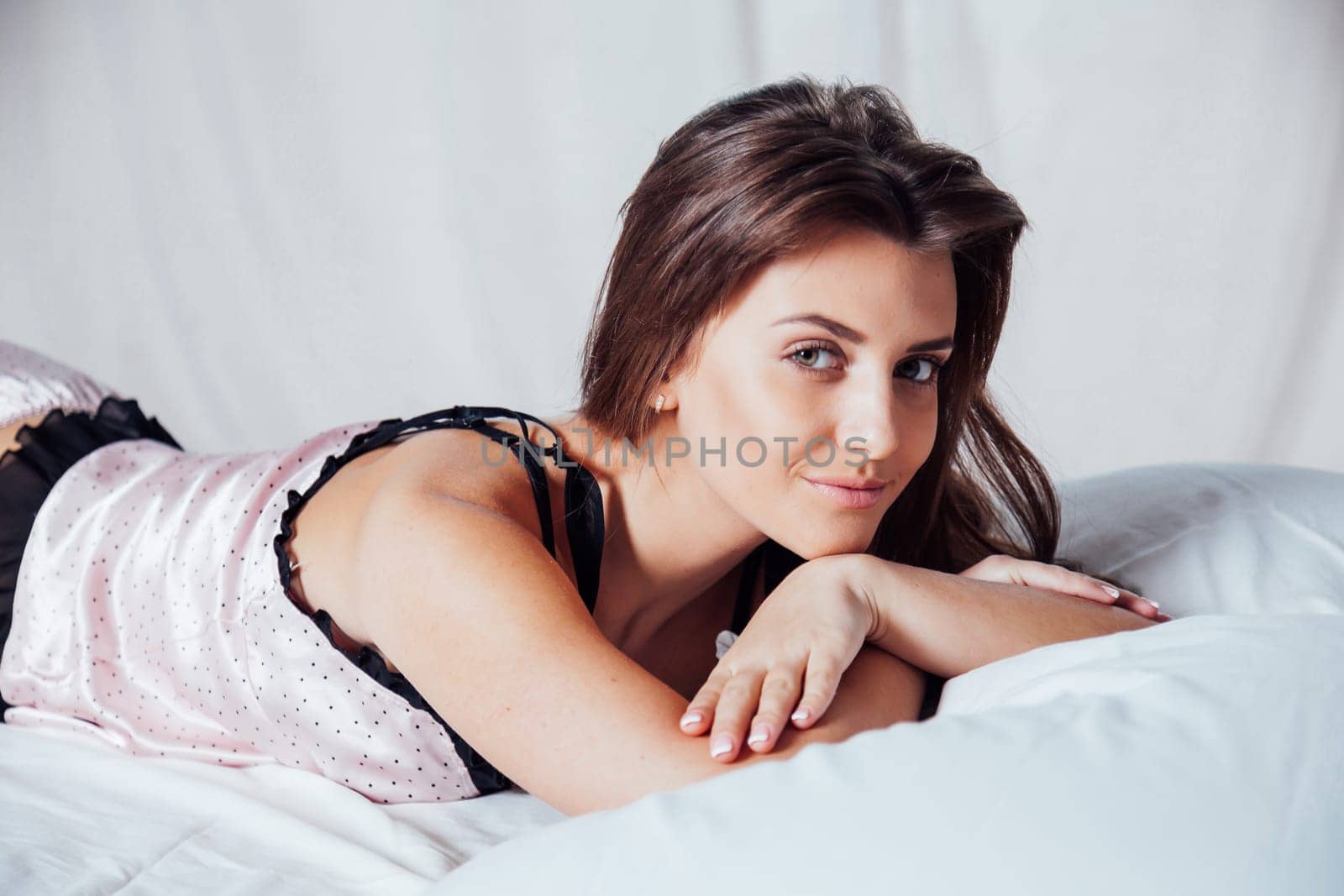 girl in pink underwear on a white bed