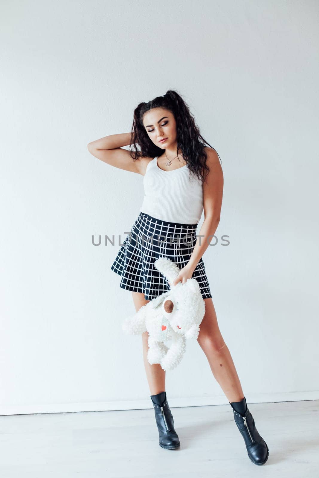 Portrait of a beautiful woman with a soft polar bear toy