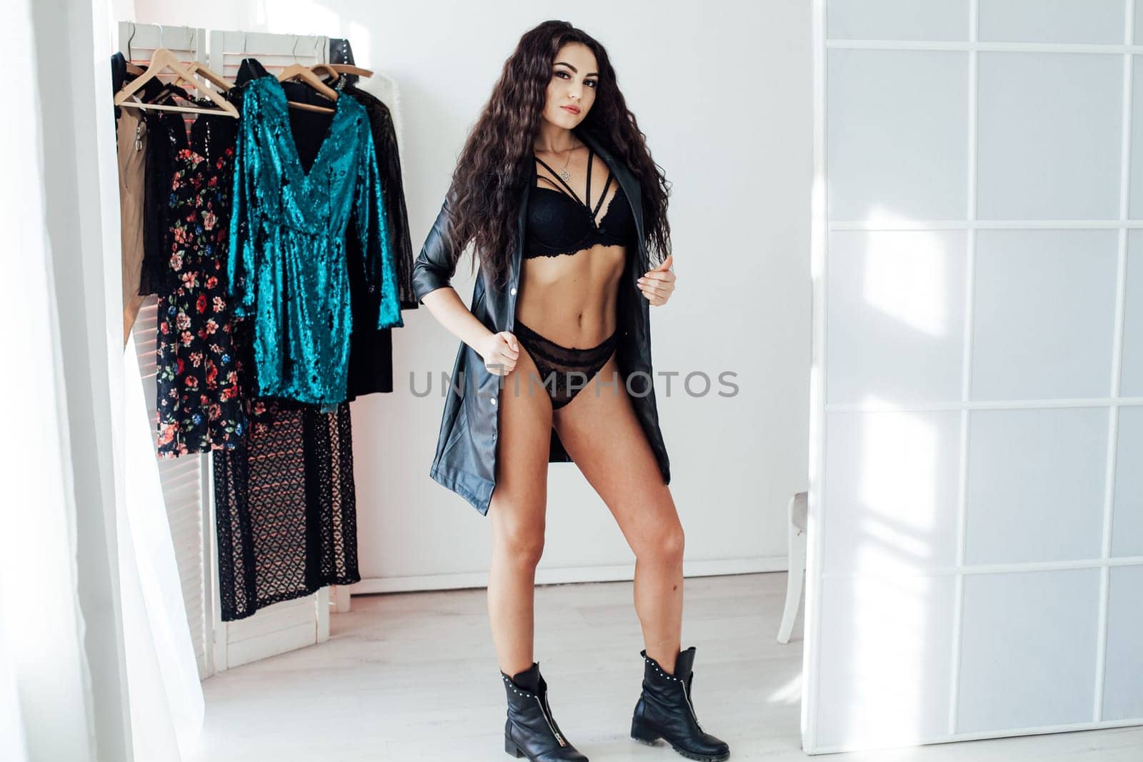 Beautiful woman in lingerie takes different clothes in the wardrobe