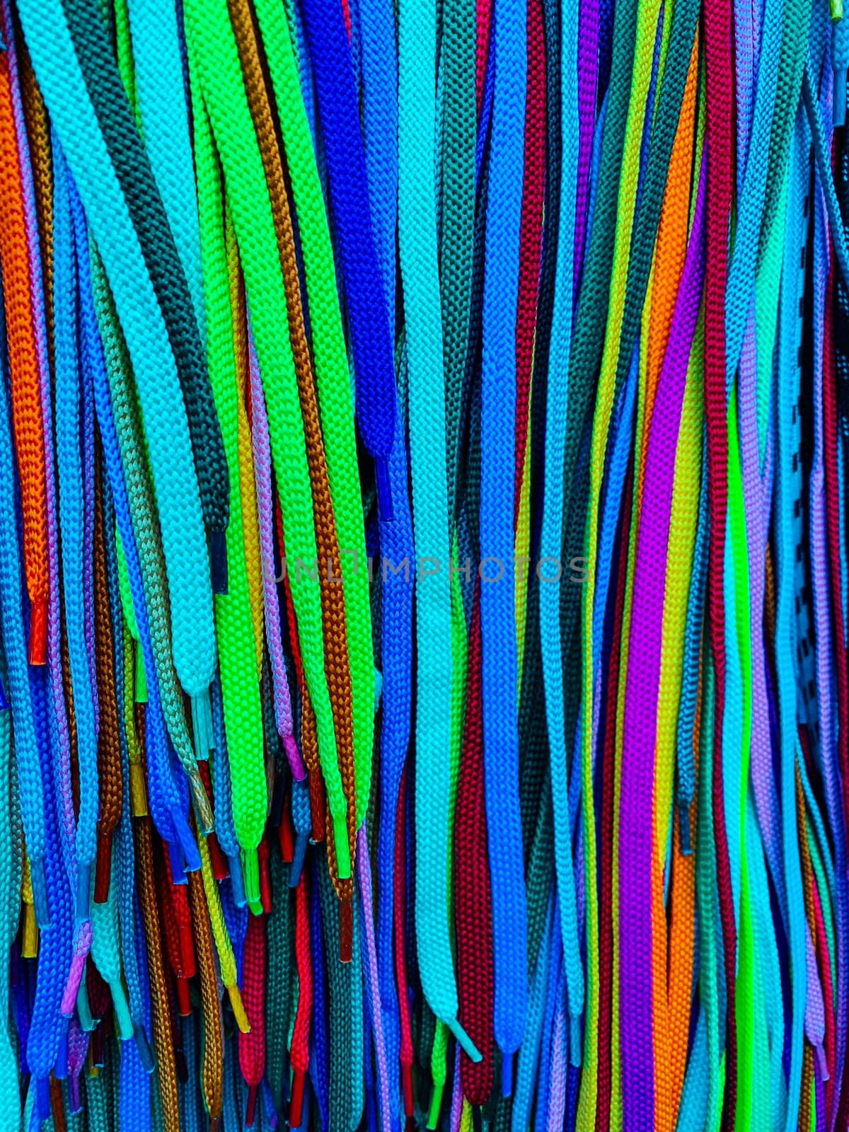 Lots of multi-colored shoelaces as a colored background by Simakov