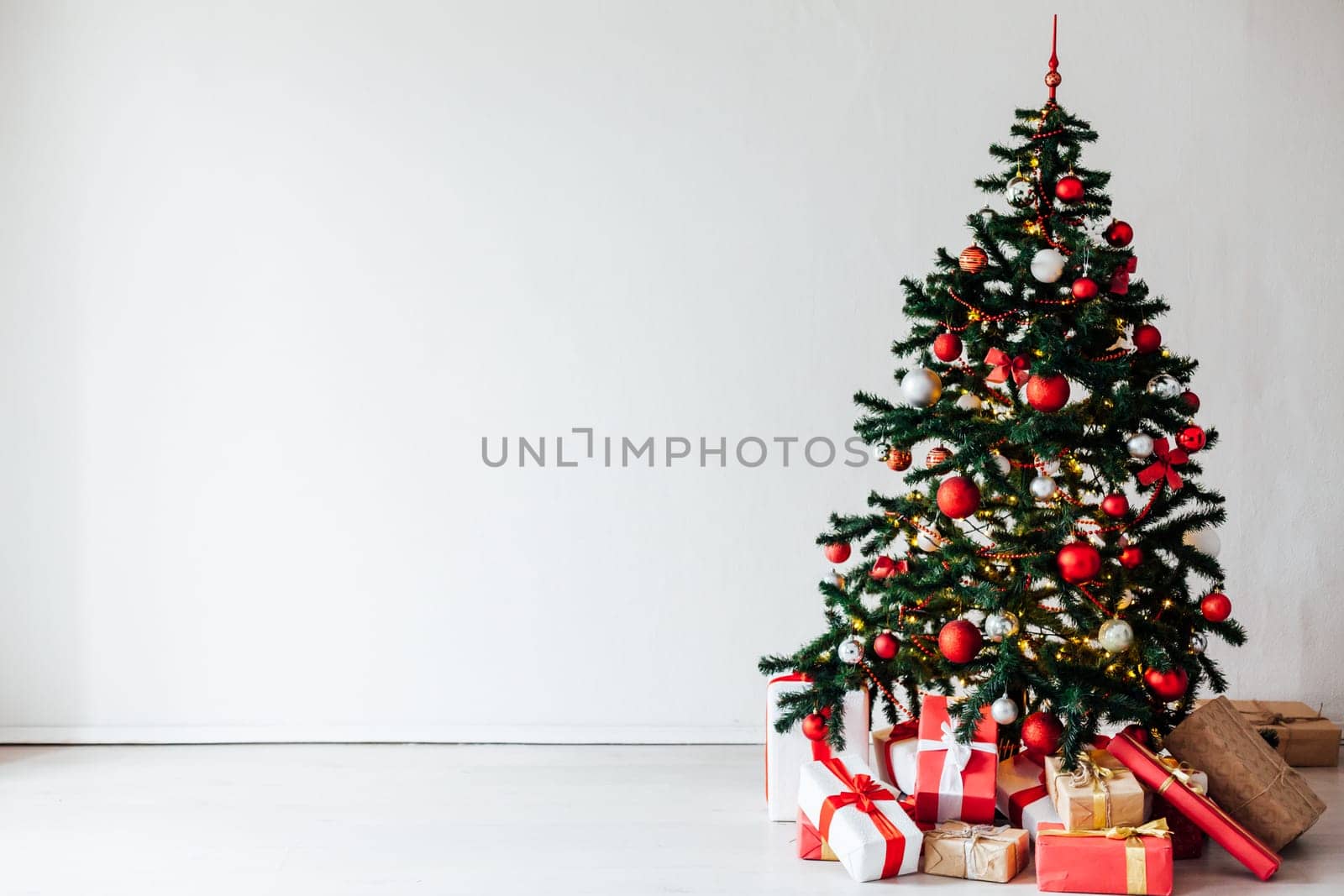 Christmas tree with red gifts decor white interior for the new year by Simakov
