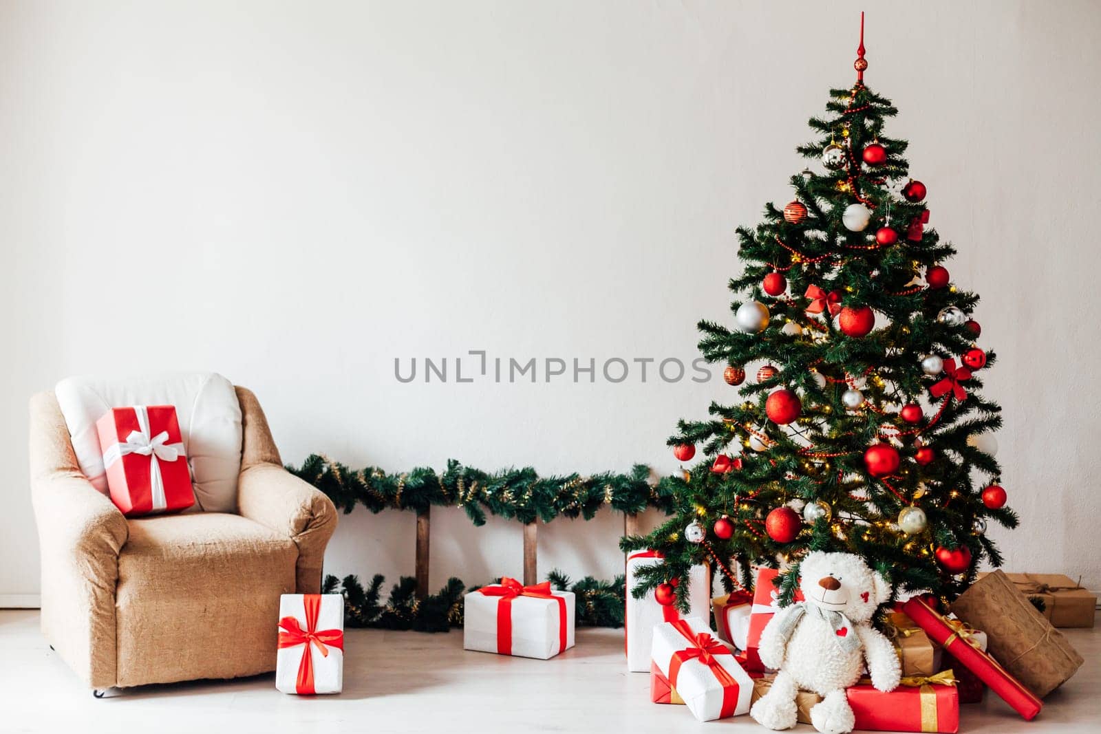 Christmas tree with red gifts decor white interior