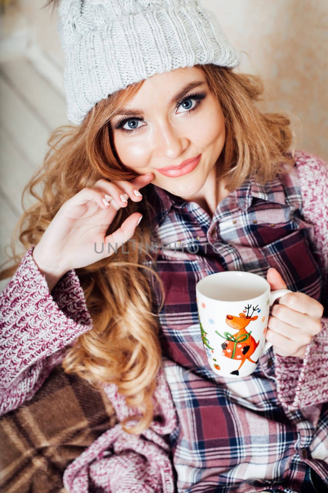 a girl sits in a chair with cup of coffee or tea cold