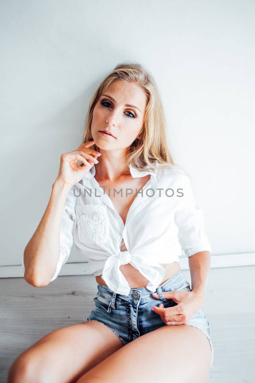 Portrait of a beautiful blonde woman with blue eyes by Simakov