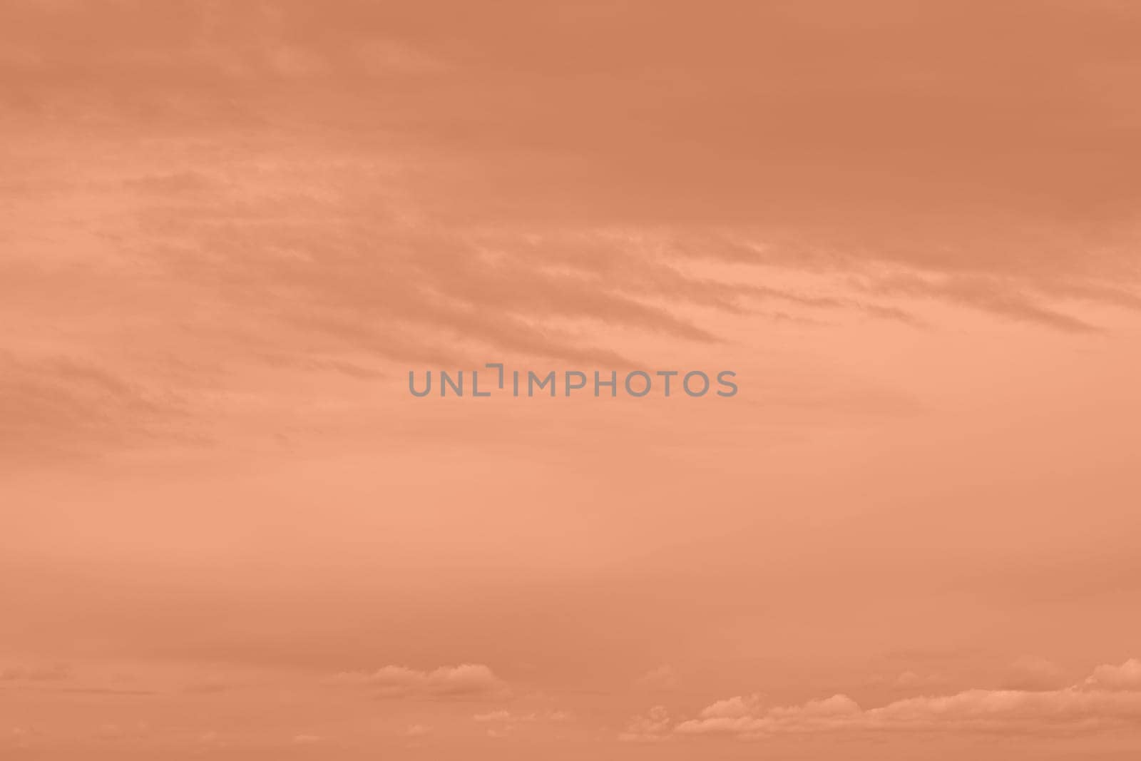 Peach Fuzz toned sky and clouds. Monochrome background 2024 color of the year. High quality photo